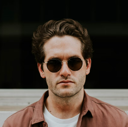 a man with dark hair and sunglasses